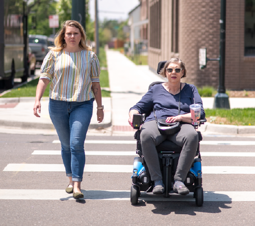 Travel trainer and trainee crossing the street