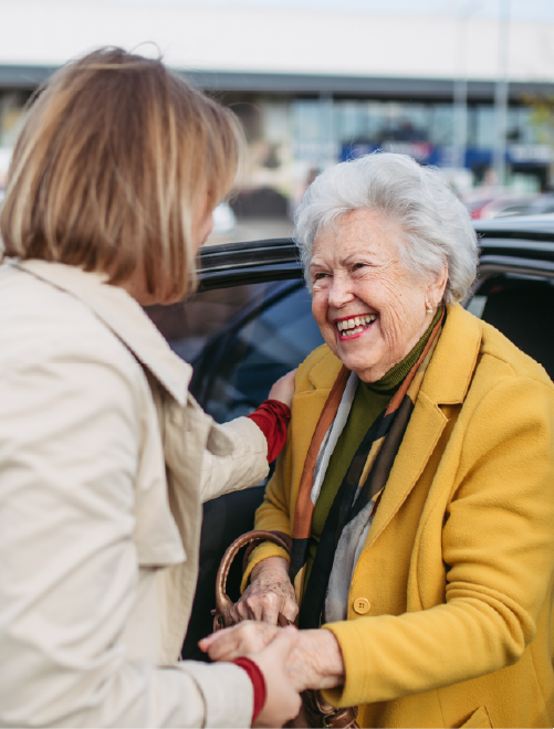 Driver assisting senior passenger out of vehicle